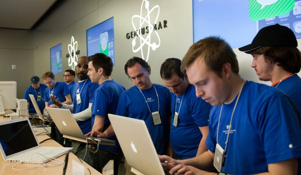 Apple employees work behind the Genius Bar at the Apple store in Bethesda, MD.