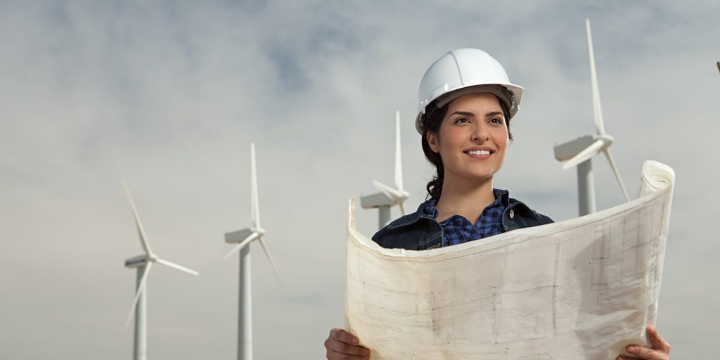 Female engineer at wind farm with plans