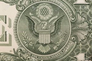 A one dollar bill close up, showing the eagle on the great seal of the United States.